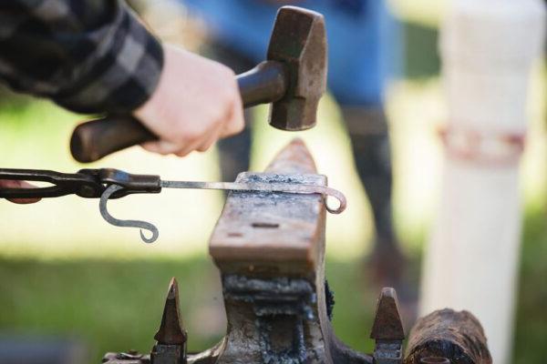 a blacksmith hammering iron